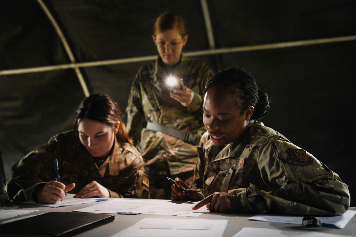 airwomen collaborate in tent